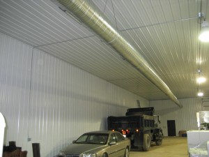 A high efficiency heating and cooling system for a storage warehouse, complete with spiral ductwork.